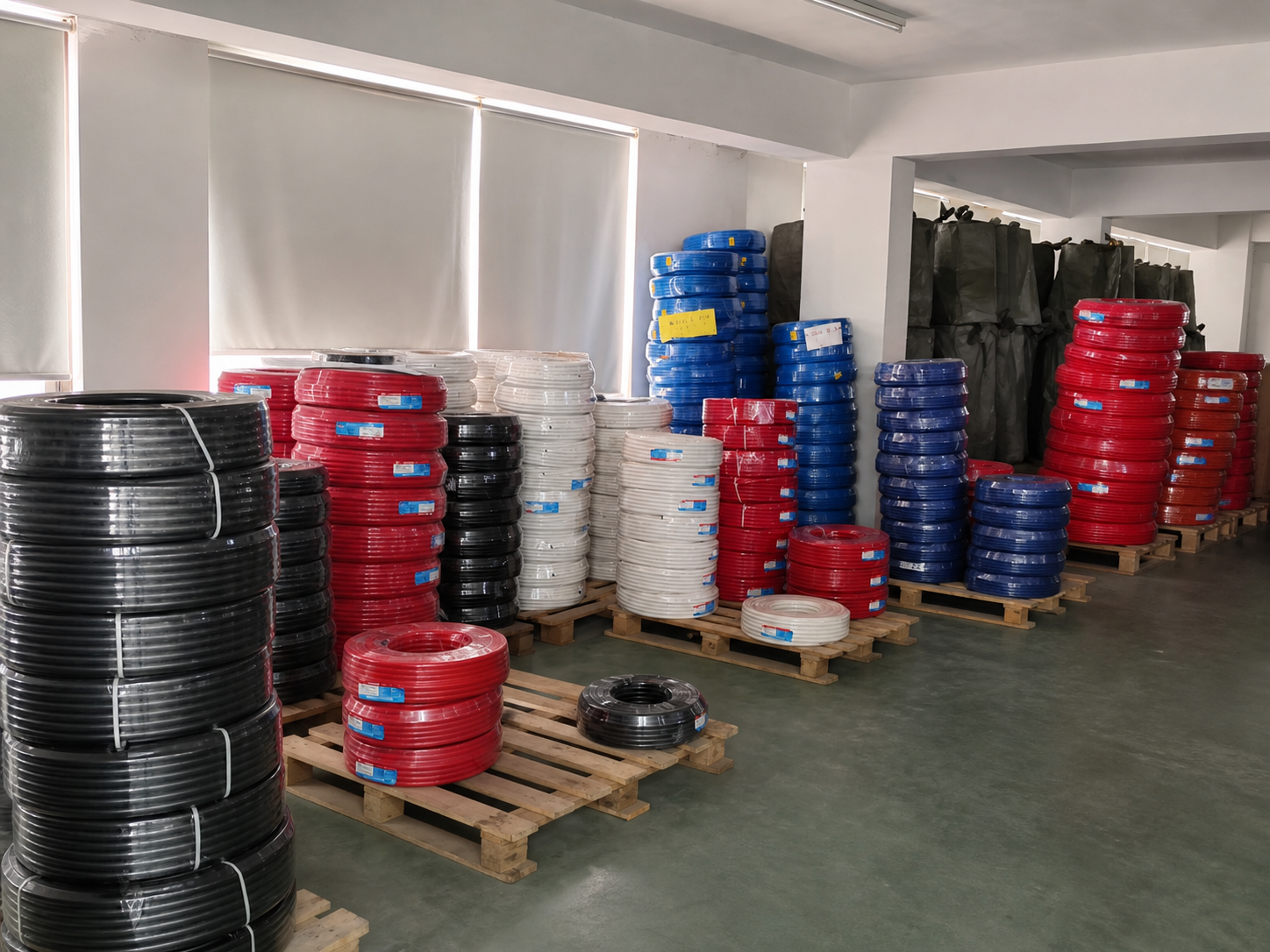 Clean presentation overview derived from the real HOLID stock-room walkthrough, showing mixed wrapped tube coils on pallets